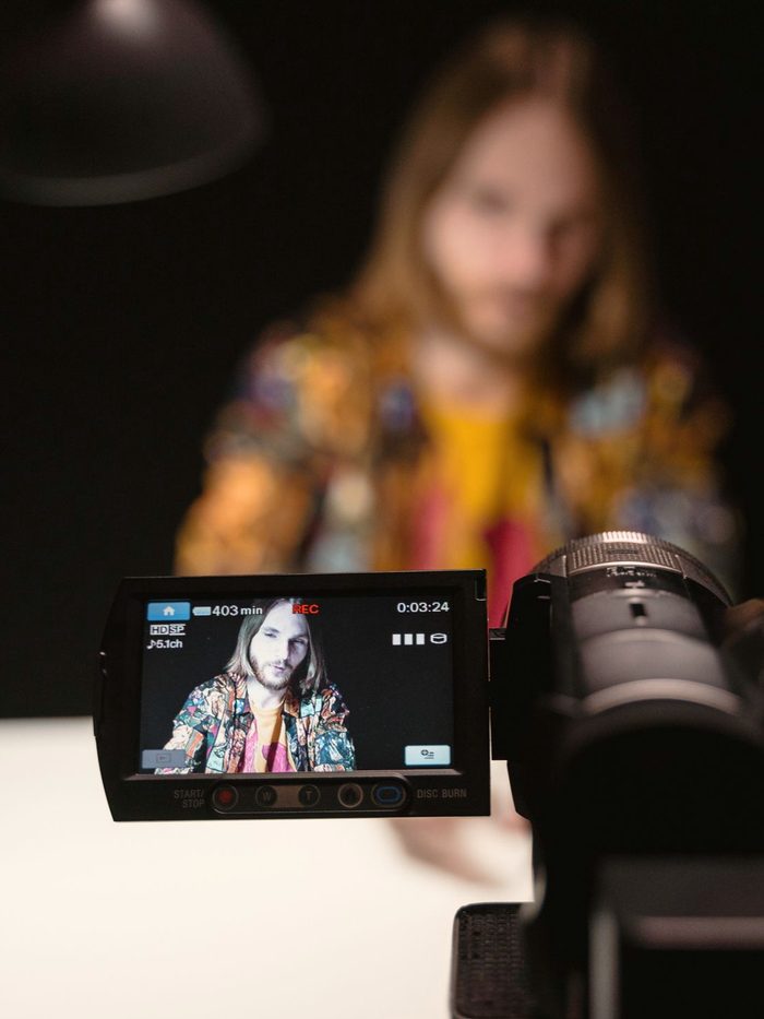 A creator being filmed on a professional camera, mid-recording: the long-form content you already have
